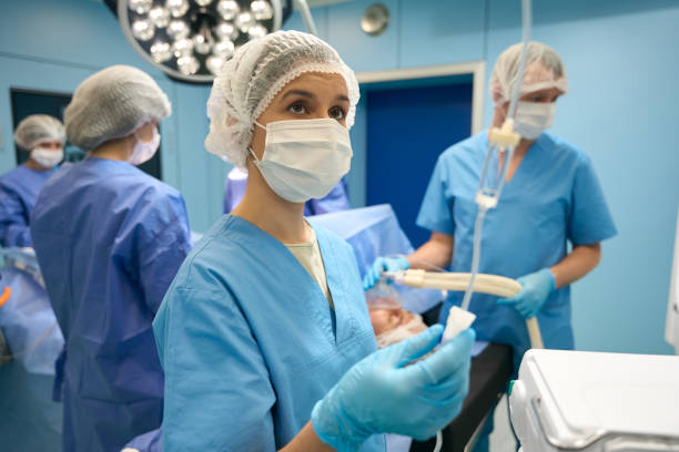 istock Woman assistant controls flow of medication through adropper to patient 1485187988