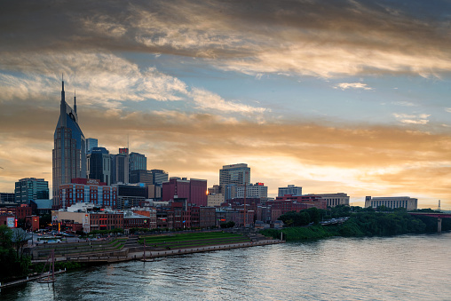 Scene of the downtown Nashville skyline in the late afternoon towards a golden hour sunset