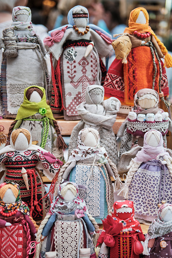 Slavic traditional little dolls made of rags - amulets associated with pagan traditions. Handmade souvenirs or gifts on market.