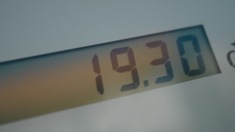 Gas station fuel meter counter close up while refueling a car,increasing petrol costs