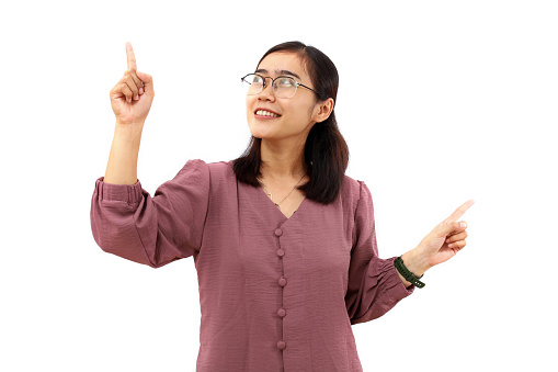 Happy Young asian woman standing while pointing both sides. Isolated on white background