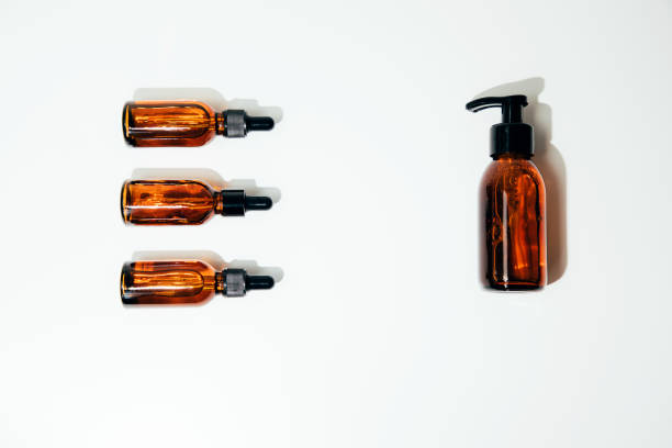 istock Group of clear amber bottles with natural cosmetics on a white background 1485190830