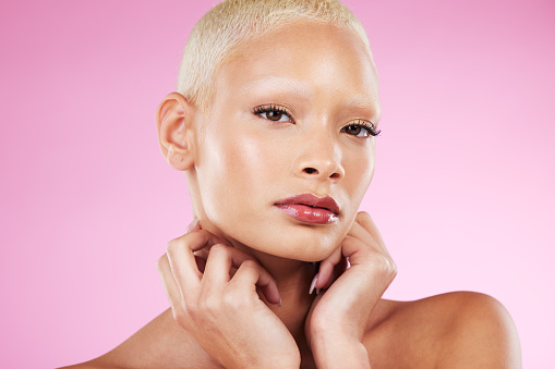 Portrait, beauty and skincare with a model black woman in studio on a pink background for edgy cosmetics. Face, makeup or natural with a unique and attractve young female indoor for cosmetic care
