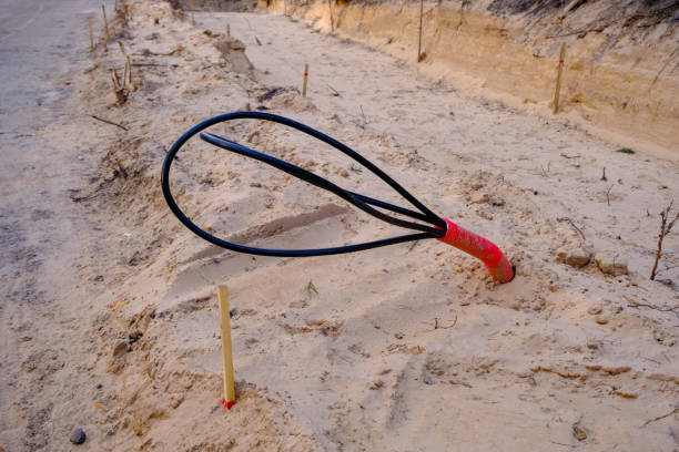 istock Construction of a new road in the initial stage. . construction of communications. Cables for light poles 1485193295