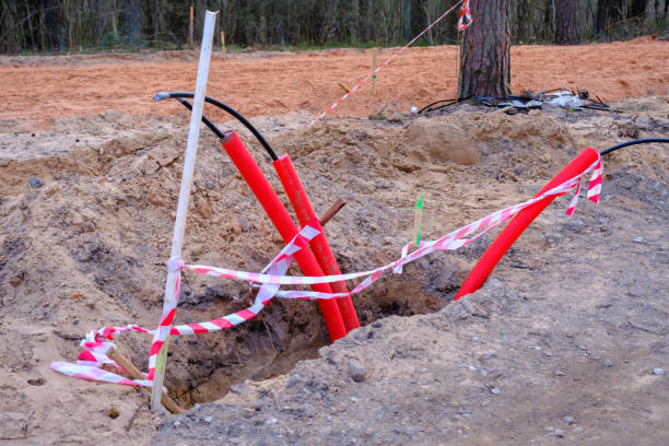 istock Construction of a new road in the initial stage. . construction of communications. Cables for light poles 1485193302