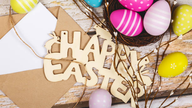istock Mockup white greeting card, easter eggs and envelope on a wooden background 1485196260