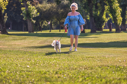 Middle age woman enjoying time with her dog in the nature