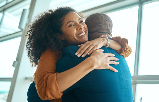 Couple hug, reunion at airport and travel with love, care and relationship, happy to see partner with black people. Hello, happiness and commitment, traveling and embrace, together and greeting