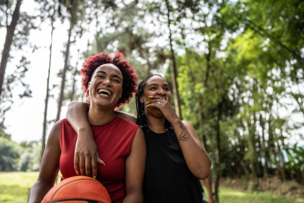 Basketball female friends walking on a public park