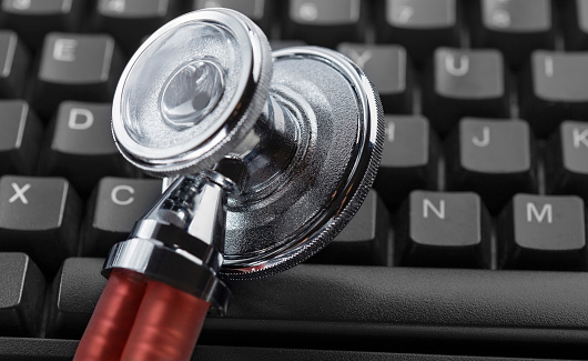 Online medicine stethoscope on computer keyboard. Modern medicine.