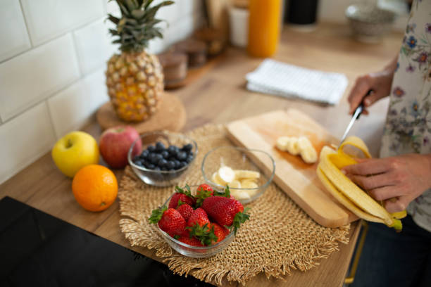 istock A woman prepares a fresh fruit salad 1485201606
