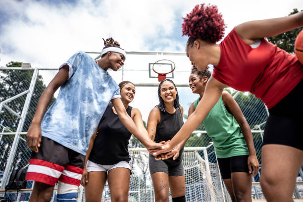 istock Friends stacking hands at a sports court 1485201783
