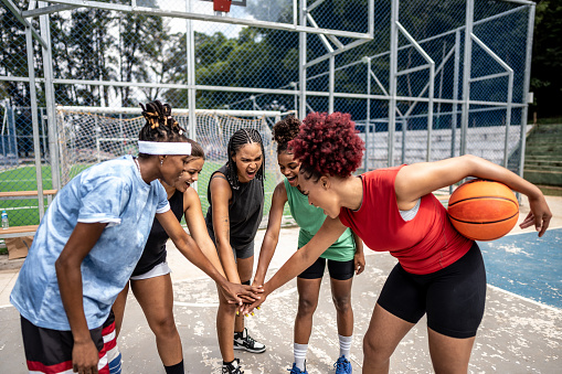 Cinematic Action TV Shot of a Strong Athlete Running to Score a Goal at a Basketball Match. Two Strong Multiethnic Teams Fighting for a Spot in the Playoffs. Excited Crowd is Cheering for Players.