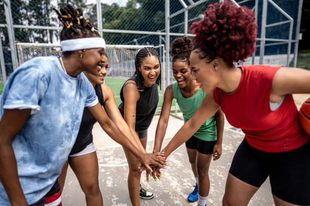 istock Friends stacking hands at a sports court 1485201827