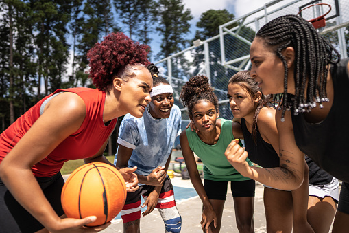 Women basketball team talking in sports court