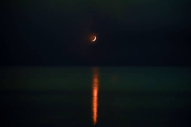 istock Waxing moonset over the Baltic sea during the polar lights (Aurora borealis) 1485202704