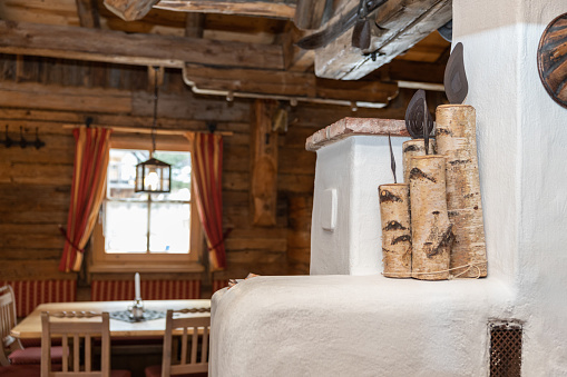 Wooden churbaks and oven as a design element in the interior of an alpine restaurant in Austria. High quality photo