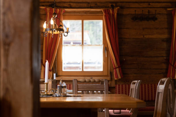 istock A distant view of a lighted window in a rustic restaurant in Austria 1485204236