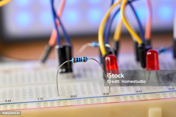 Breadboard With Electrical Elements On A Wooden Table Stock Photo - Download Image Now