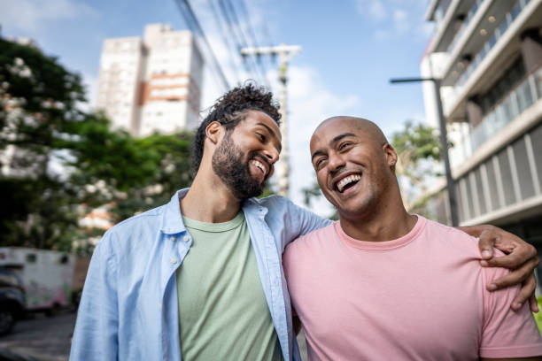 istock Gay couple talking while walking in the street 1485204840
