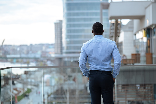 A young African-American businessman looking at the distance