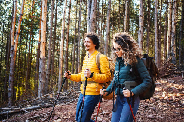 istock Young adventurous couple with backpacks hiking in the forest 1485212768