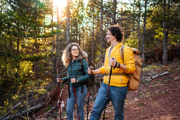 istock Young adventurous couple with backpacks hiking in the forest 1485212824