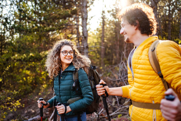 istock Young adventurous couple with backpacks hiking in the forest 1485212880