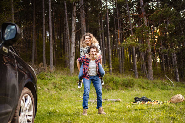 istock Young couple having fun on a meadow while men is carrying his girlfriend on his back 1485212975