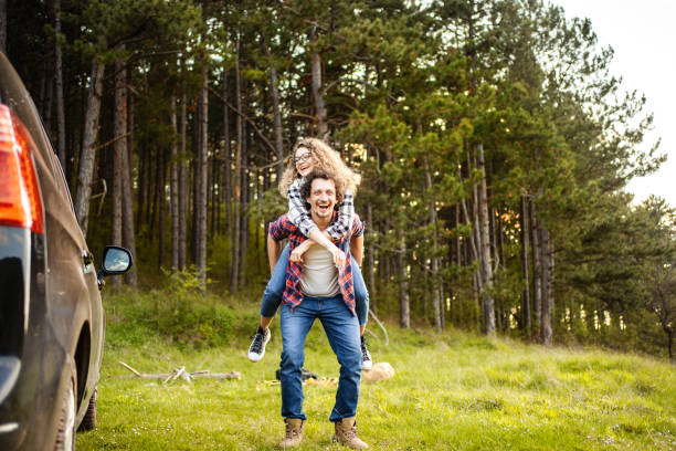 istock Young couple having fun on a meadow while men is carrying his girlfriend on his back 1485213006