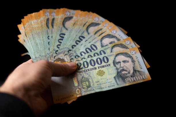 hungarian huf 20,000 banknotes in human hand on black background - market european culture caucasian stock market imagens e fotografias de stock