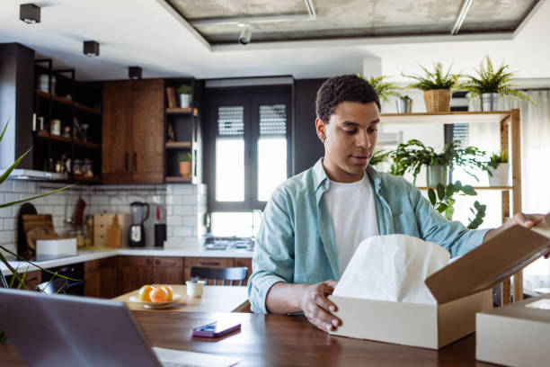 istock A Black man unboxing online purchase at home 1485217556