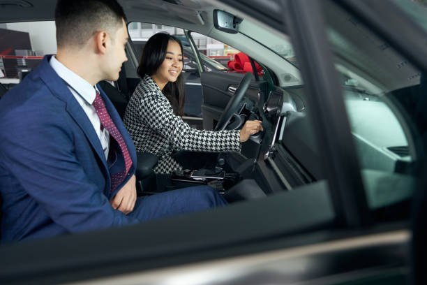 istock Calm young consultant communicates with a cute client in car 1485220002