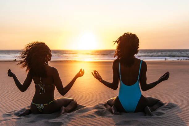 back view of Content black woman on tropical beach at sunset
