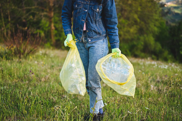 istock volunteer collecting plastic trash in forest. 1485223878