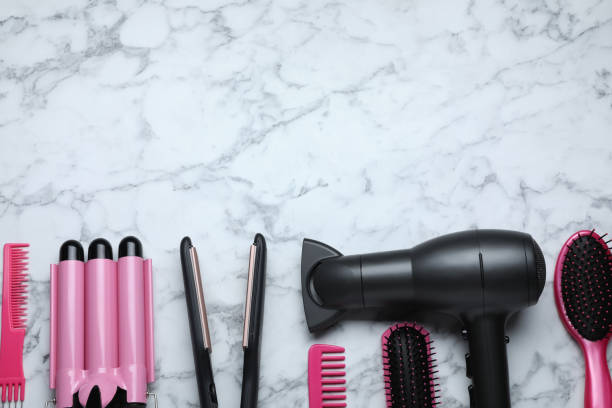 istock Flat lay composition of professional hairdresser tools on white marble table, space for text 1485224685