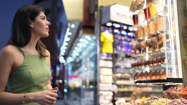 Mid adult woman looking at spice store