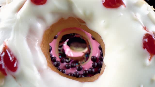 Many bright and colorful sprinkles donuts, macro shot. stock video
