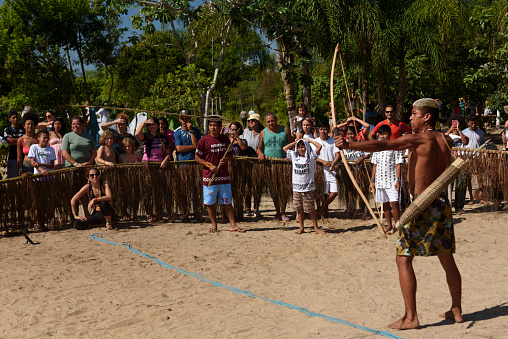 Peruíbe, SP, Brazil - April 23, 2023: \nAn indigenous man shoots an arrow during a competition in the Tapirema village
