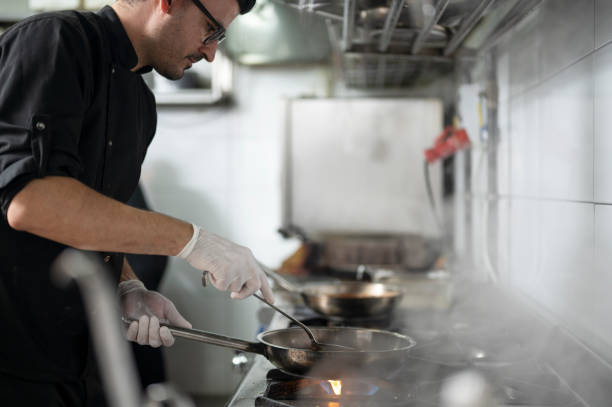 istock A male chef in restaurant kitchen at stove with pan 1485229466