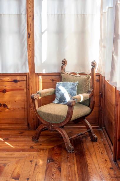 istock Antique armchair in a wooden room with bright windows. 1485231663