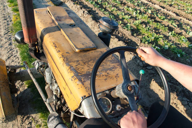 A red cargo tractor loaded with barriers for construction purposes.
