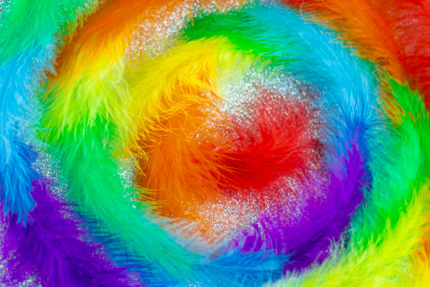 istock Spiral of colored feathers on a silver background. 1485234405