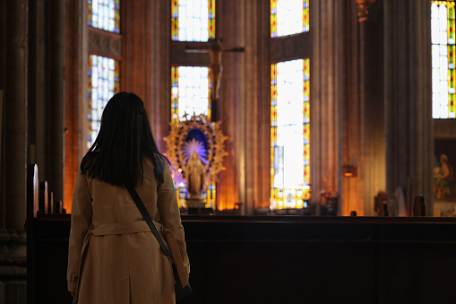 Woman praying in church