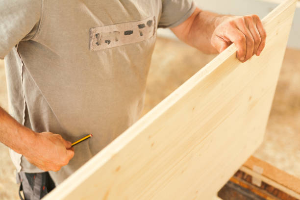 istock Carpenter holds wood tightly 1485236367