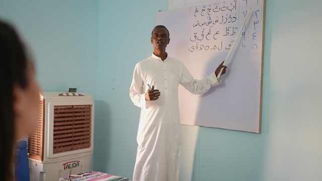 Teacher teaching arabic language to students in the classroom