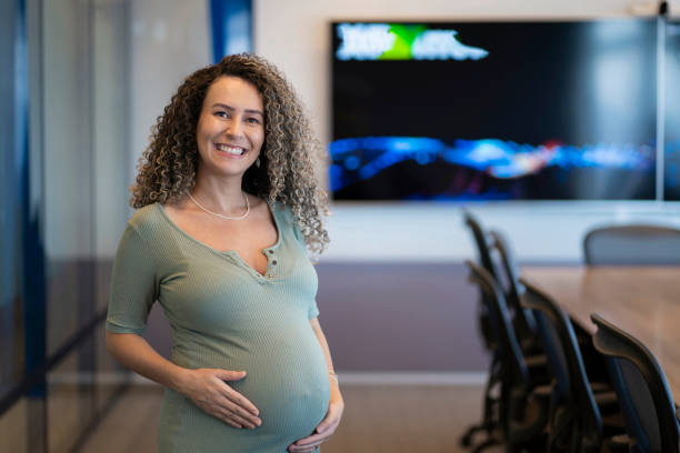 Portrait of pregnant business woman in the office stock photo