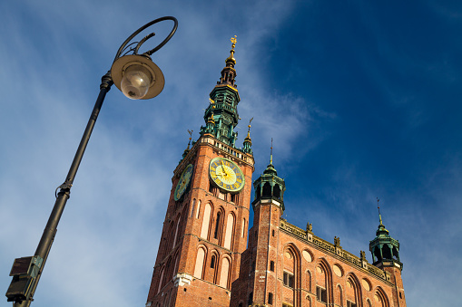 The Main Town Hall clock tower rises high up in the sky above Gdansk's old town.