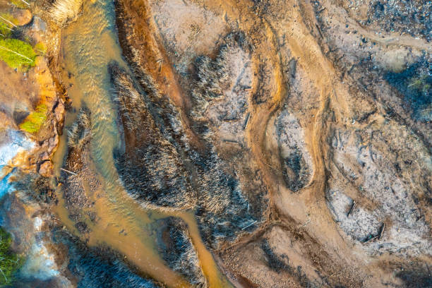 istock Dried rusty river bed over wasteland grey background, contamination texture, drone view directly above. 1485241959