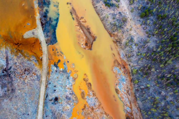 istock Dried rusty river bed over wasteland grey background, contamination texture, drone view directly above 1485242962
